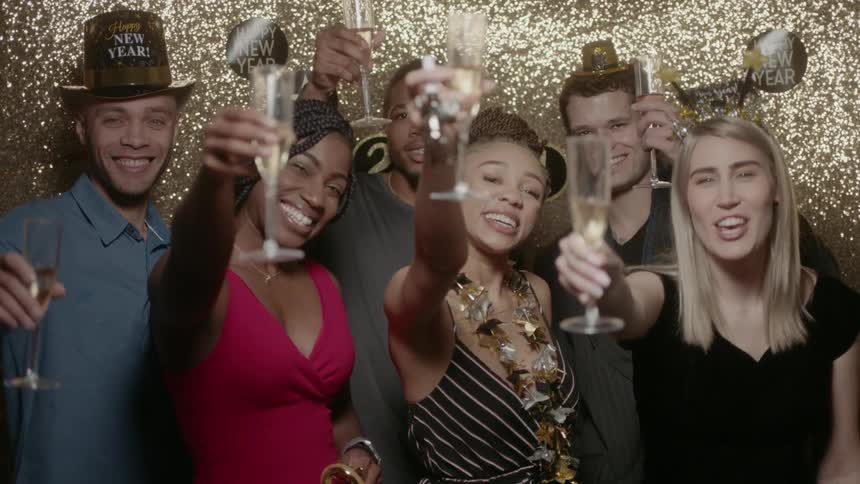 Friends smile and celebrate the new year with champagne