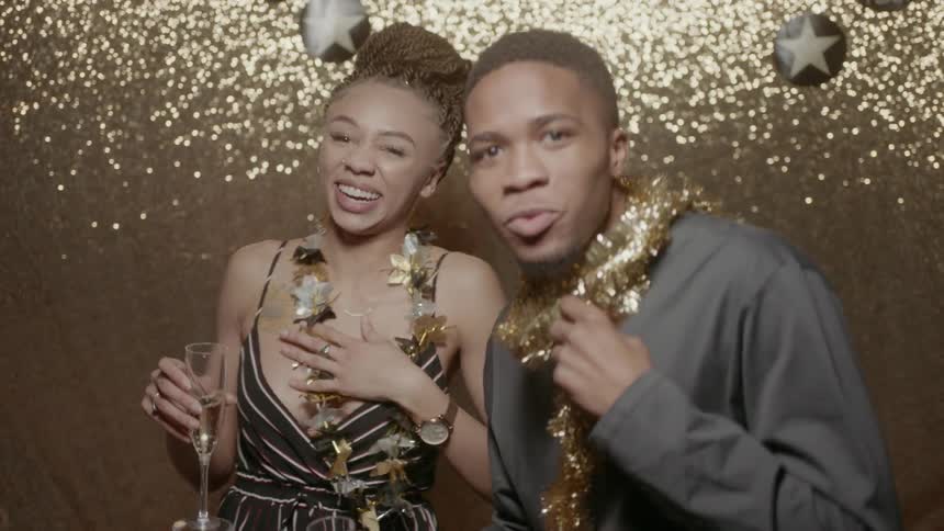 A man and woman are dancing and celebrating while toasting with champagne