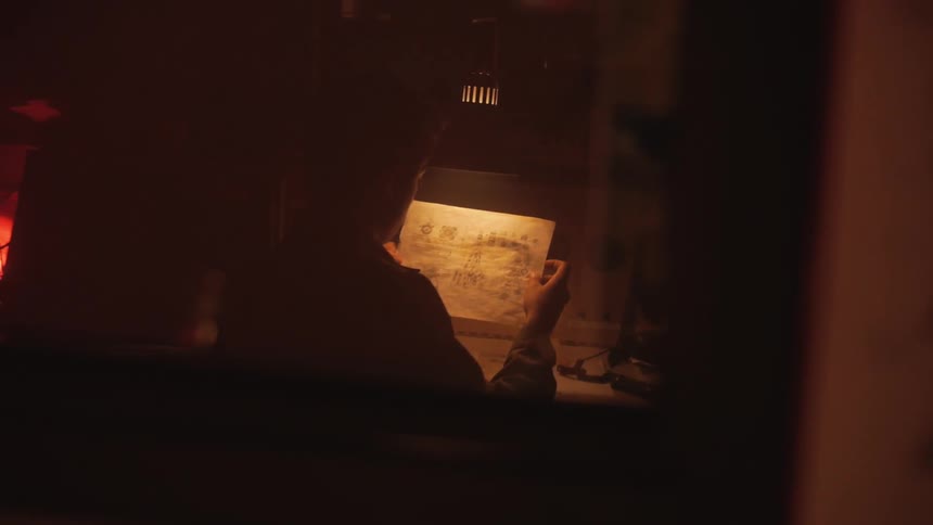 A person looking at drawings