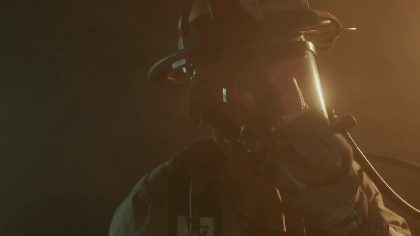 Smoke floats around a firefighter