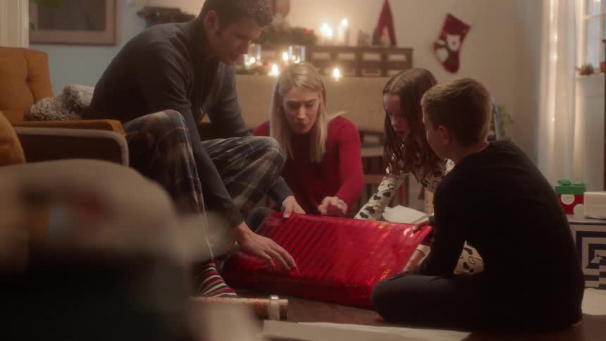 A family work to wrap a present together