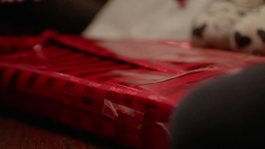 A girl wraps a present