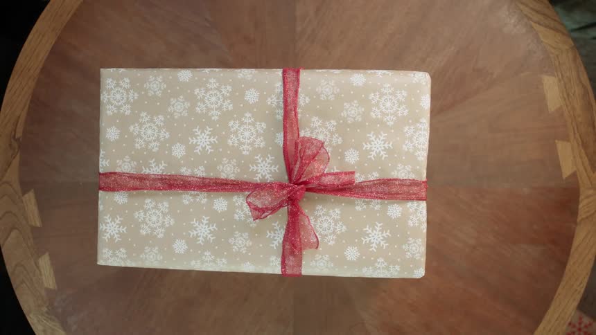 A christmas gift is placed on a table