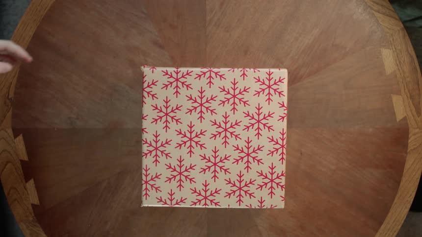 A christmas gift is placed on a table
