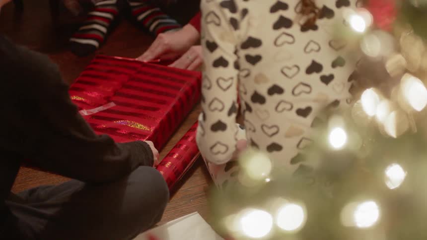 Children watch as a present is wrapped