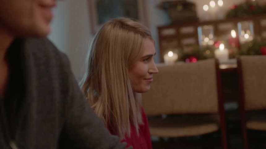 A man and woman smile at christmastime