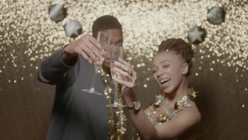 A man and woman celebrate the new year with champagne