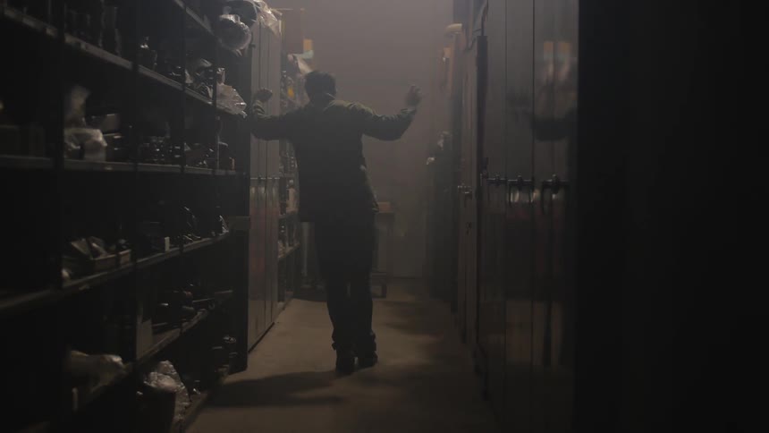 Person walks in a dark locker room