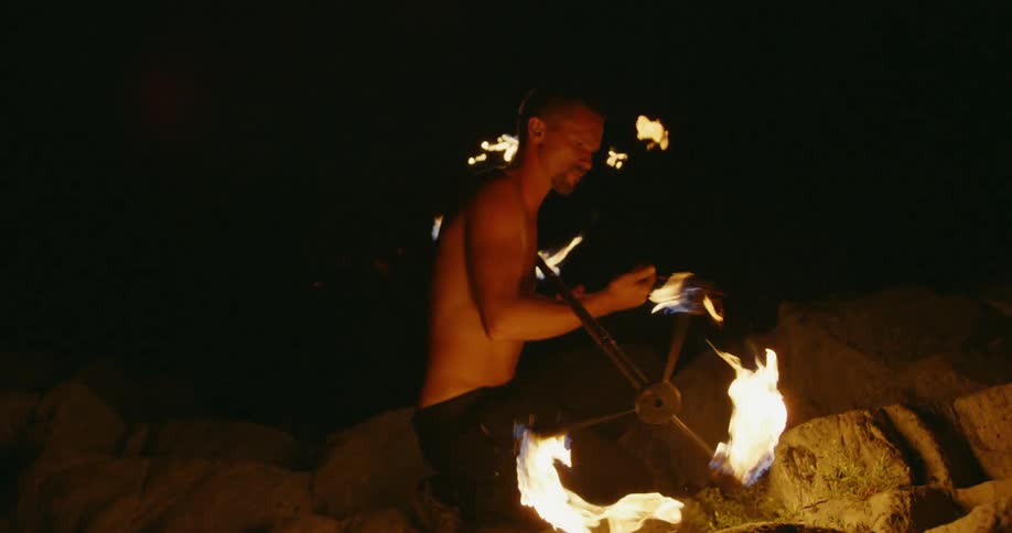 A man dancing with fire