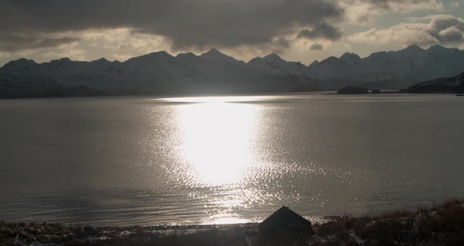 Sunlight reflects on a body of water in the mountains