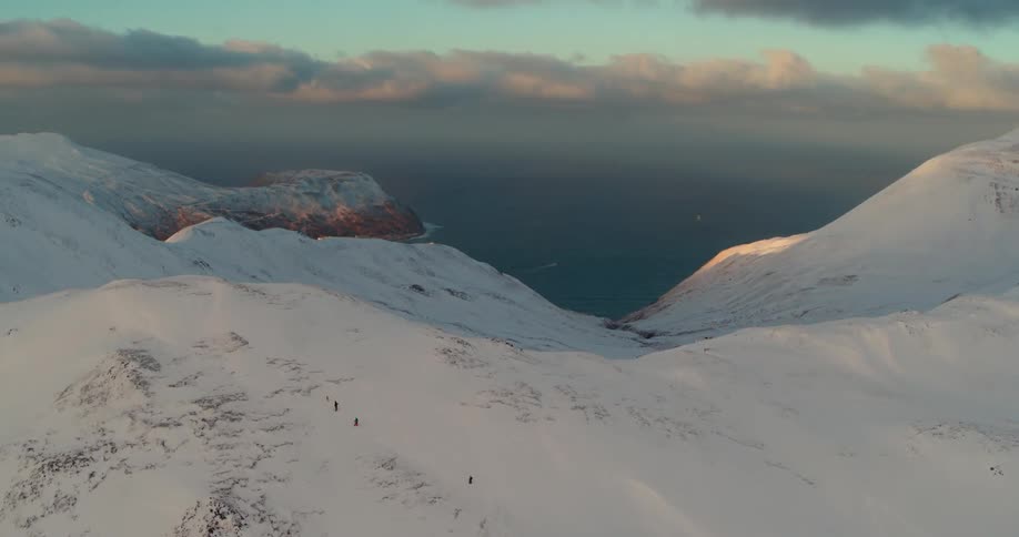 Hikers climb up a snowy mountain