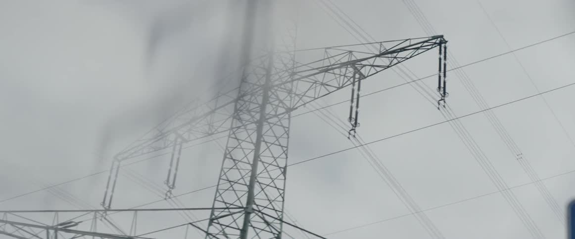 A vehicle drives beneath power lines