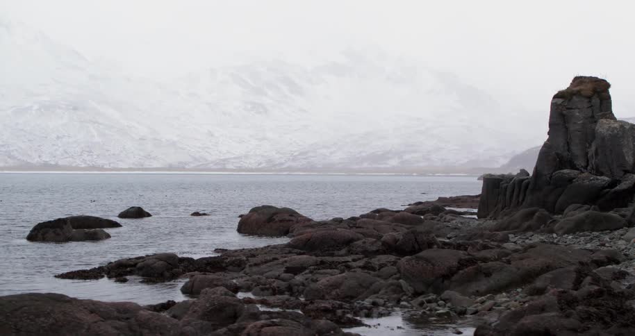 Rocks sit on a lakeshore