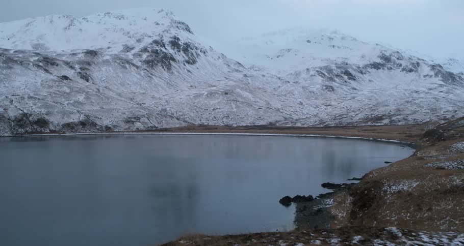 Snowy mountains surround a bay