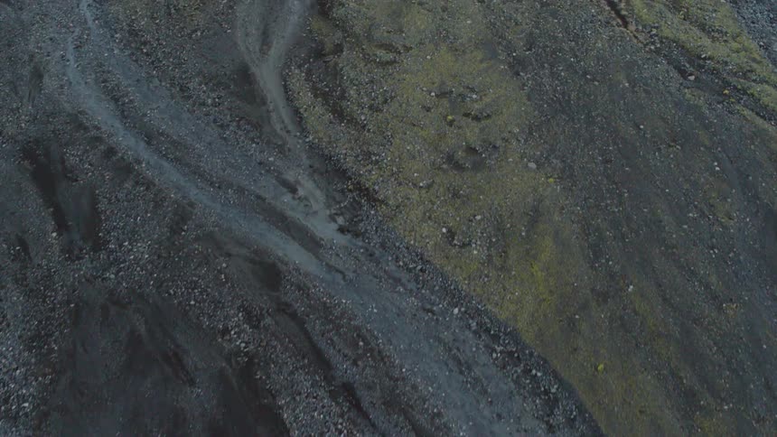 Black dirt trails are flown over by a drone
