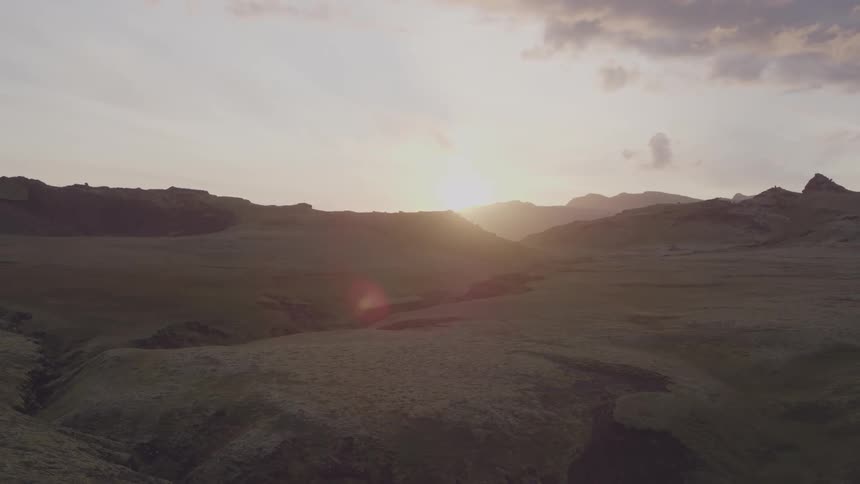 The sun sets over mountains