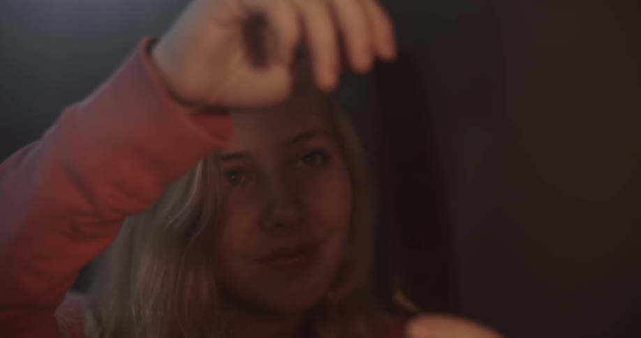 A woman looks at camera film