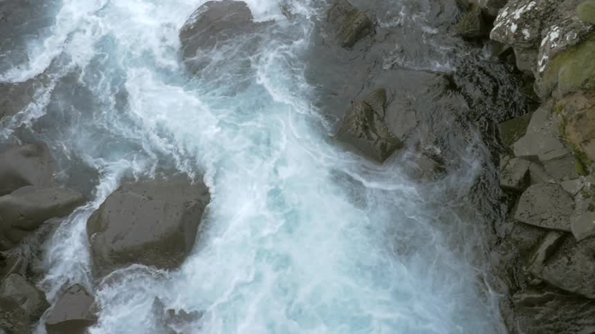 A river roils as it runs through large rocks