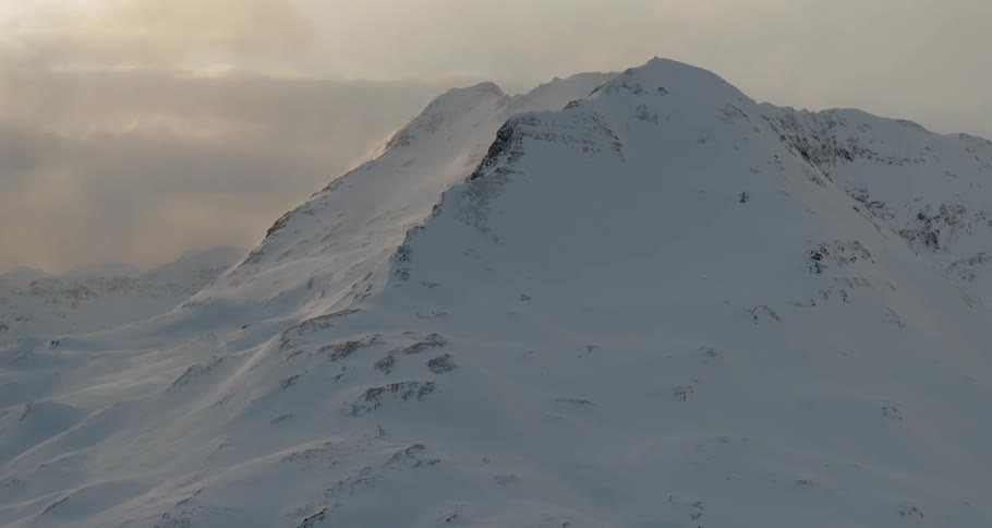 Snow-covered mountains on a cloudy day