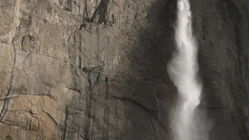 Slow motion of a waterfall falling down a cliff
