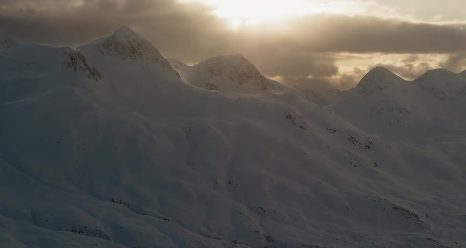 Snow covered mountains are being flown past