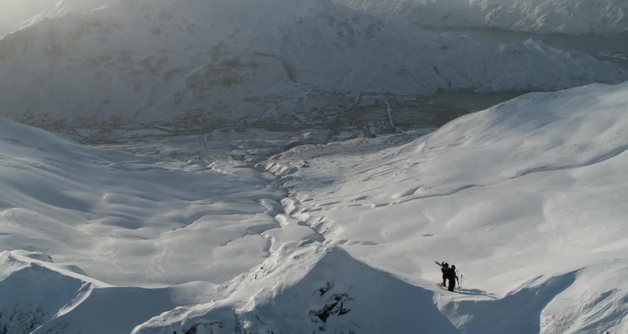 Skiers hike in snowy mountains