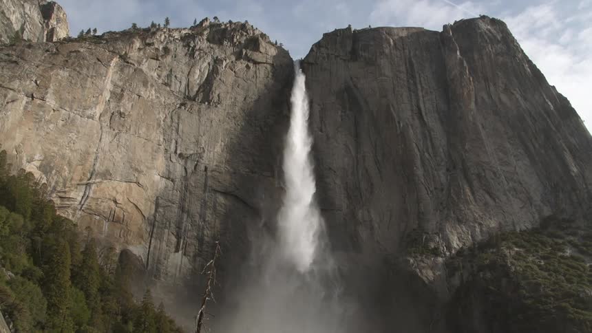 A waterfall falls over a mountain