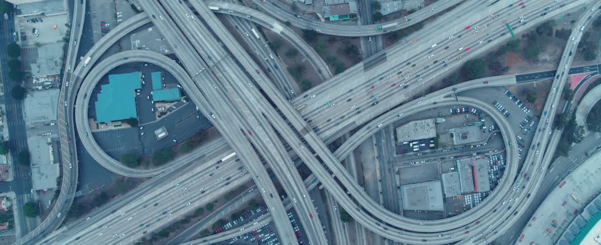 Cars travel on a highway with loops and overpasses