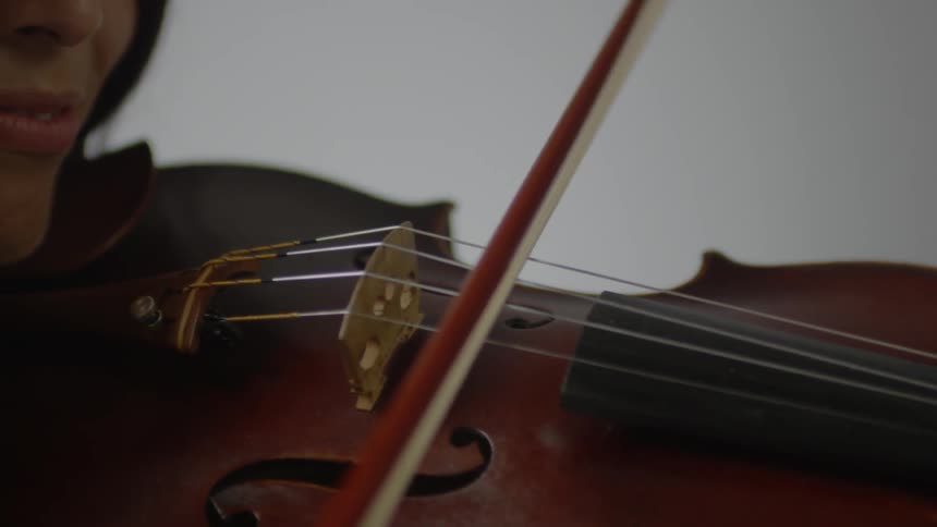A woman is playing a violin