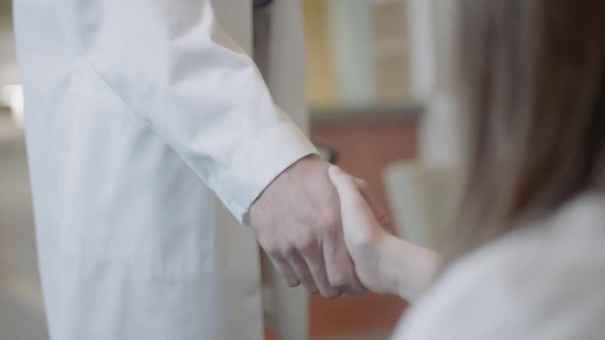 Doctor and patient shake hands