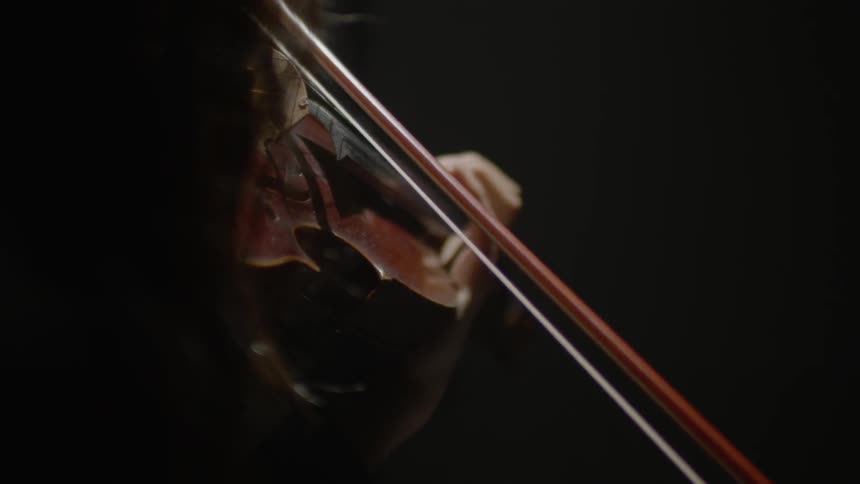 A lady is playing violin