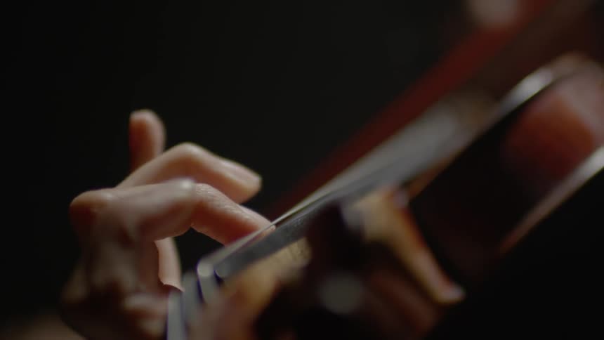 A woman plays a violin