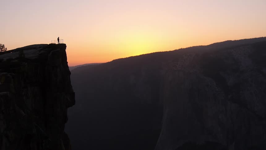 A person standing on a cliff edge