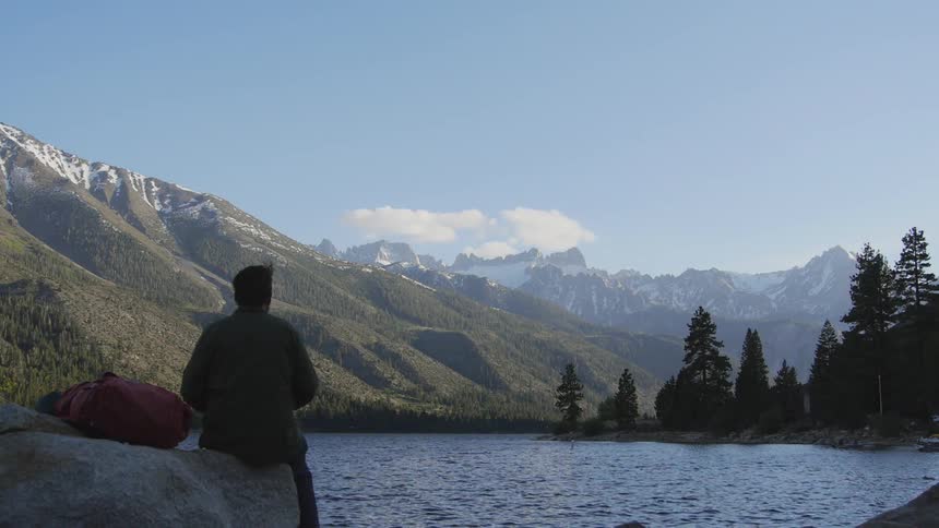 A person sitting by a lake