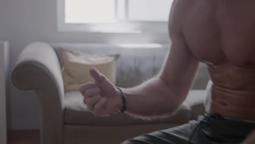 A man removes athletic tape from his hand