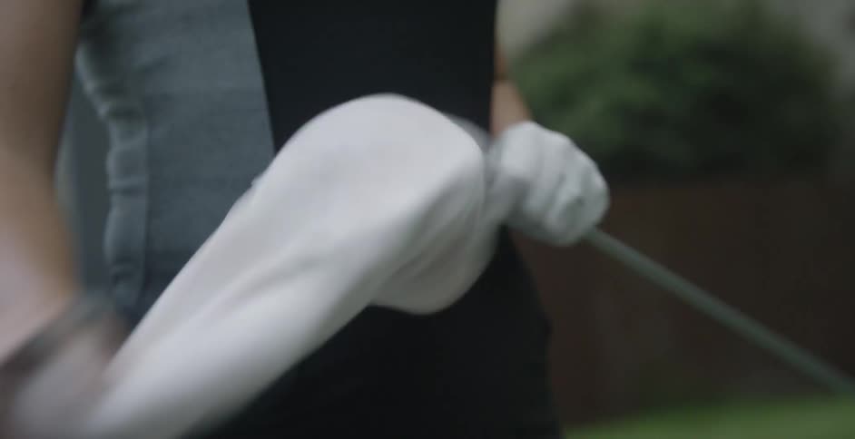 Woman selects and removes hood from a golf club