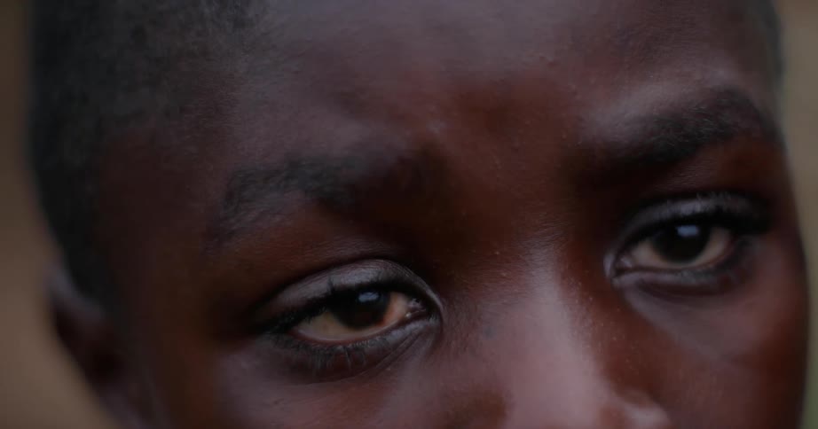 A child's face as he looks around outside