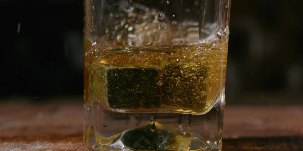 Someone dropped two whiskey stones into a glass of whiskey