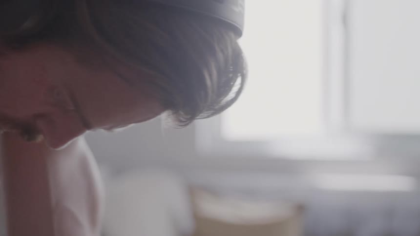A man wears headphones while working out