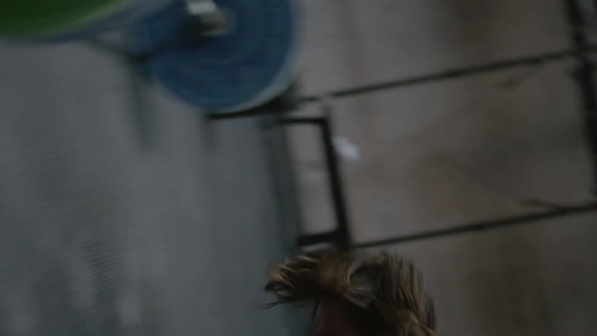 A man is doing calisthenics in a gym during the day