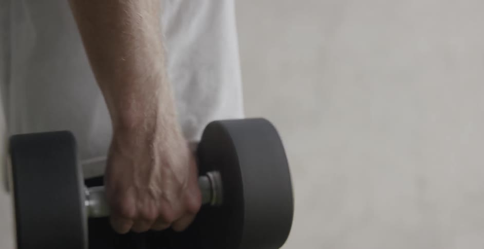 Someone is picking up dumbbells and using them