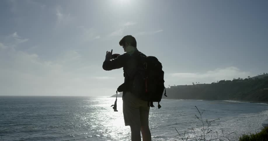 A hiker photographs the ocean