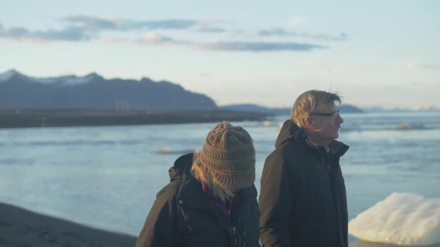 A couple walking and holding hands