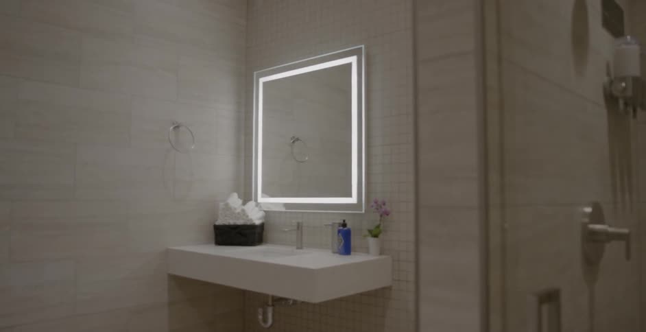 The mirror in the bathroom has lights around it