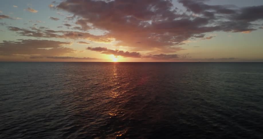 The sun is setting out over the ocean