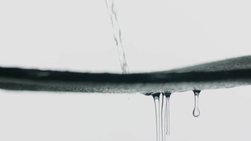 Water drips and splashes on a surface