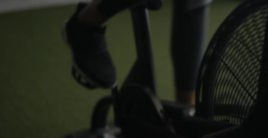 A woman exercises on a stationary bike