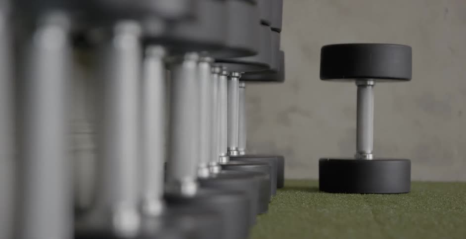 Dumbbells are sitting unused in a gym