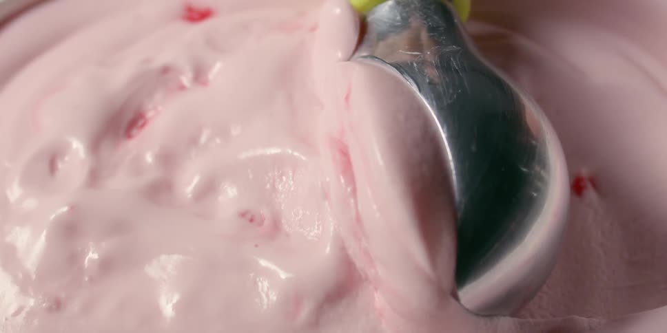Pink ice cream is scooped up