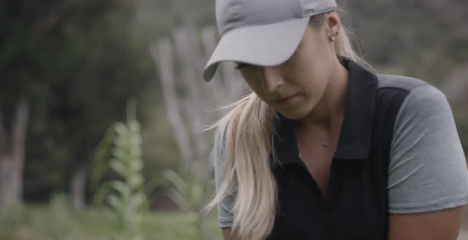 Woman lines up a golf shot